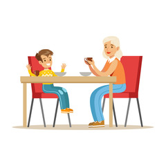 Grandmother Having Breakfast With Boy, Part Of Grandparents Having Fun With Grandchildren Series