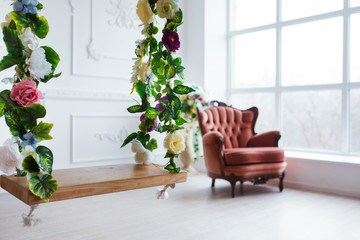 Fototapeta na wymiar Vintage style chair in classical interior room with big window and flowers