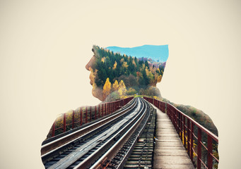 Railway bridge on the background behind the man