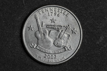 Close up of Tennessee quarter dollar coin on black background - business concept