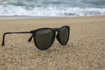 Fototapeta na wymiar Sunglasses at the edge of the beach.