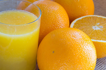 Two oranges and a half an orange; a glass of juice