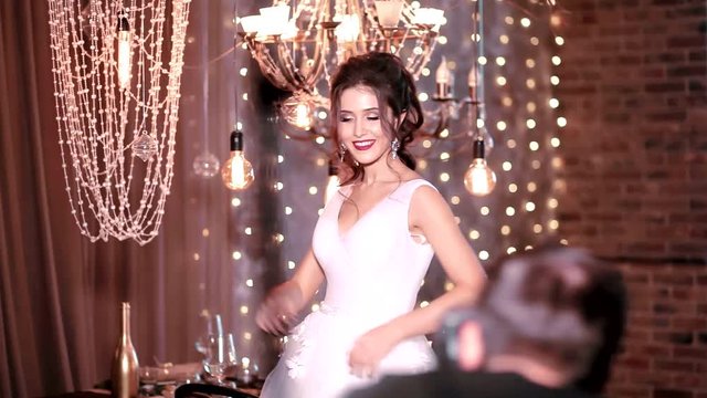Photographer takes photo of beautiful bride in interior