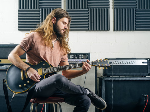 Guitarist recording tracks in the studio