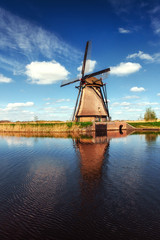 Colorful spring day with traditional Dutch windmills canal in Ro