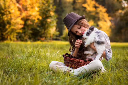 Happy little child girl with cute rabbit. Portrait of kid  with pet. Easter.