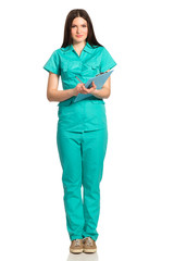 Young female doctor in uniform with clipboard writing