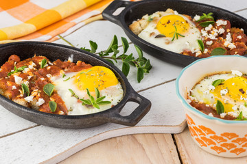 Shirred eggs with marinara and feta.