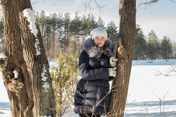 Naklejka premium young woman snow winter pine forest