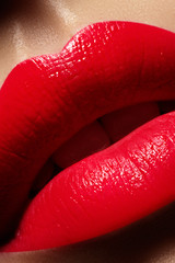 Beautiful female Lips. Sweet Kiss with red lipstick. Lip Make-up on macro shoot. Hot fashion lip makeup