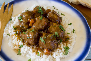 Meatballs with rice and vegetable and tomato sauce