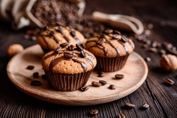 Coffee muffins with grated walnut and topped with chocolate