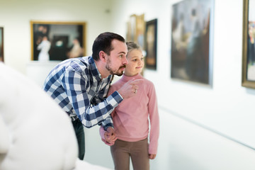 Ordinary father and daughter exploring art