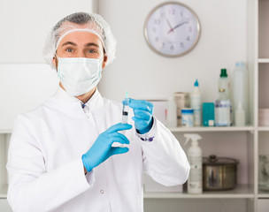 Male nurse preparing injection