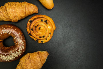Fresh baked goods on a black background, with space for text.