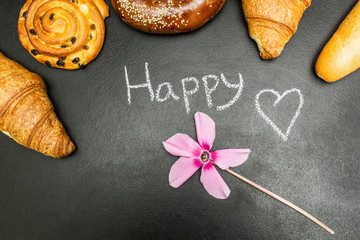 Fresh baked goods on a black background, the word 
