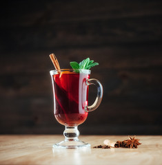 Mulled wine with slice of orange and spices. Shallow dof