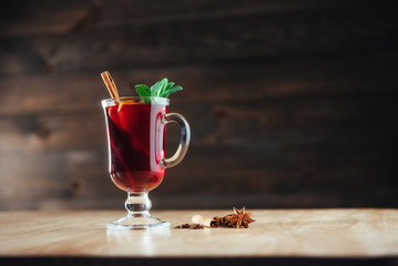 Mulled wine with slice of orange and spices. Shallow dof