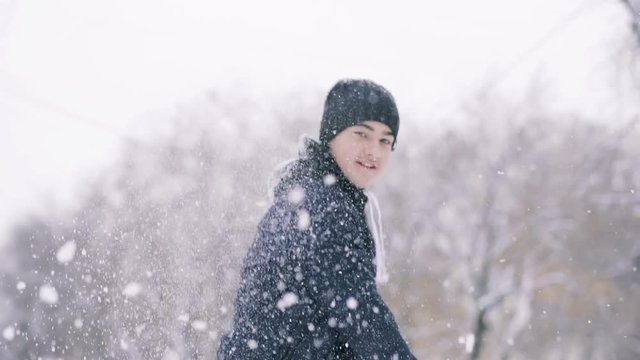 Boy playing snowballs