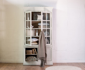 Fototapeta na wymiar steel wall tissue wooden cabinet linens set and cream blanket