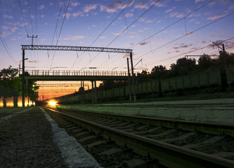 Fototapeta na wymiar The train at sunset approaches the station