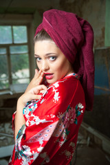 beautiful young woman wearing a towel and bathrobe at room background
