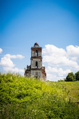 Naklejka premium Old ruined church in a green grass.
