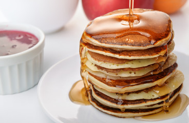 Pancakes stack pouring marple syrup