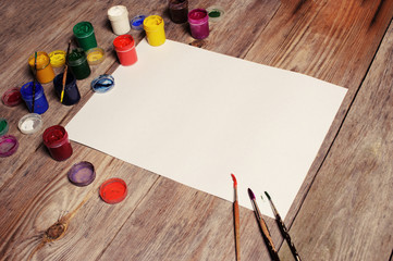 Naklejka na ściany i meble Paper, watercolors, paint brush and some art stuff on wooden tab