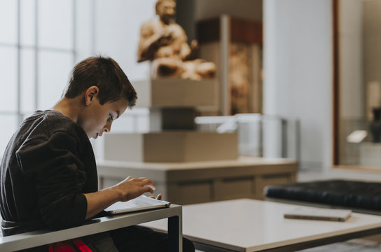 Side view of boy using tablet computer while sitting at home