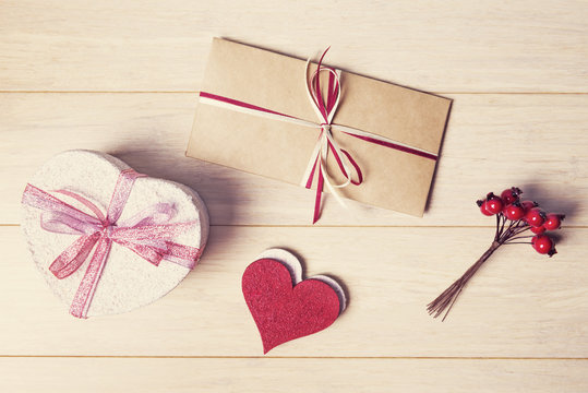 Love letter and heart shaped gift box on Valentines day