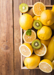 Orange juice detox juice, lemon juice, lemonade in a glass bottle in a box. Lemons in a wooden box...