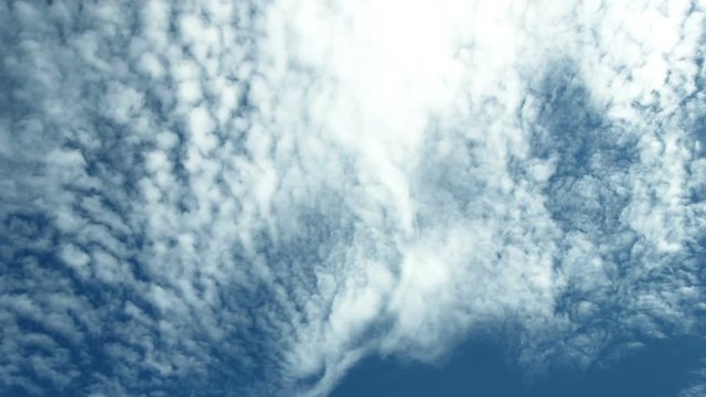 Clouds 1310: Rippled white clouds sail across a darkening blue sky.