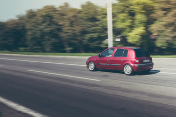 Fototapeta premium small red car speeding