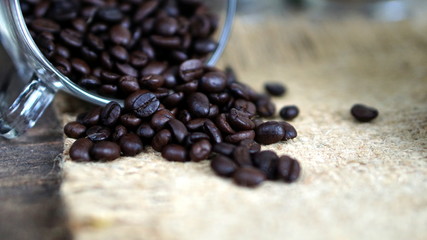 Dark roasting coffee beans put on a wood table