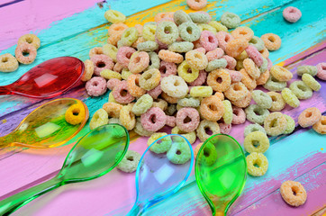 color spoon with cereal on table