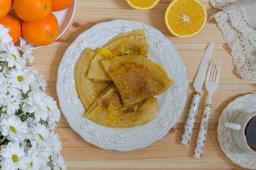 Pancakes Crepe Suzette with orange sauce and coffee    