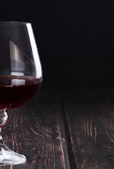 Glass of red wine on wood