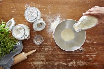 hand pouring flour into bowl homemade cooking