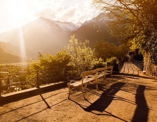 A bench in front of the hills during sunset