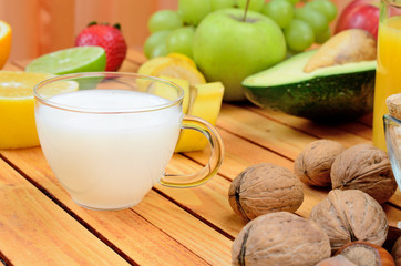 cup of milk with fruit on table