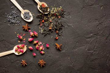 Obraz na płótnie Canvas Herbs on spoons black background mock-up top view