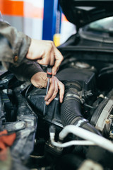 Obraz na płótnie Canvas Auto mechanic repairing car. Selective focus. 