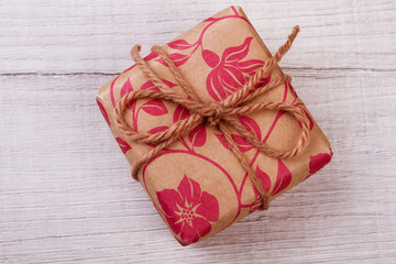 Gift box in wrapping paper. Top view of present. Beautiful present for party. Handmade surprise mockup.
