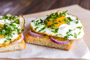 Open sandwiches with egg and cheese on a wooden background