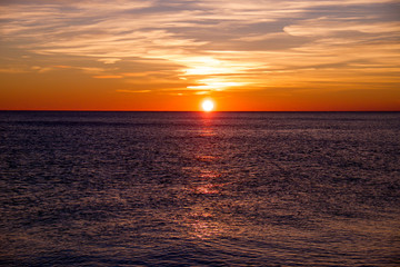 sunset casting long highlight over sea