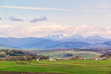 Sunny spring fields on foothills.