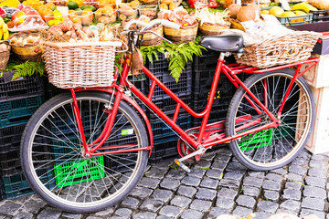 Fototapeta na wymiar Fruit market with old bike in Campo di fiori in Rome