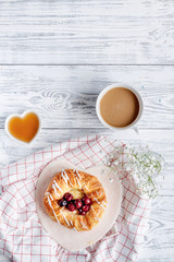 Breakfast concept with flowers on wooden background top view