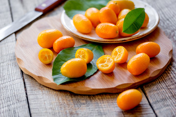 kumquat on plate at wooden table